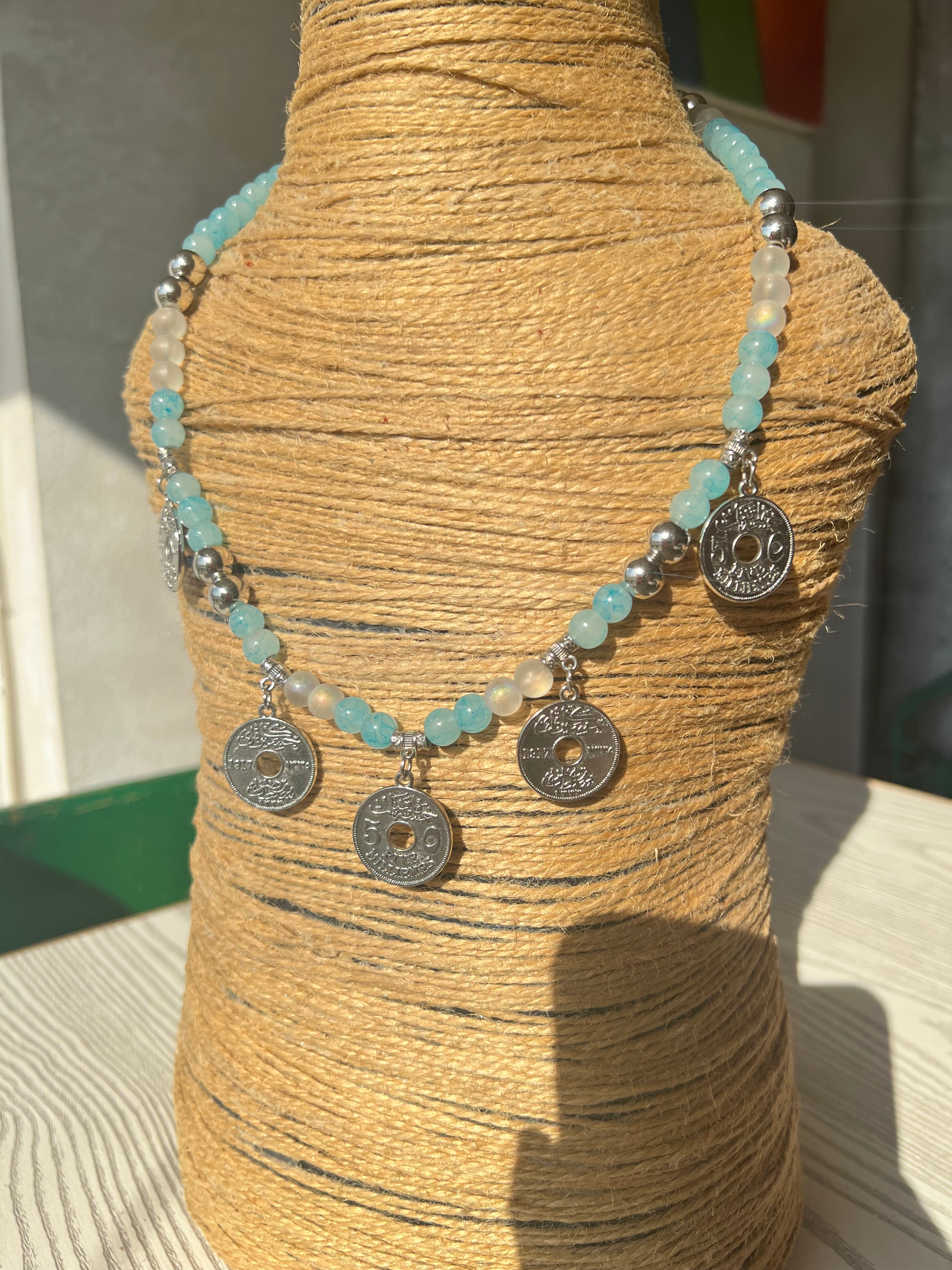 Baby blue necklace with five silver coin