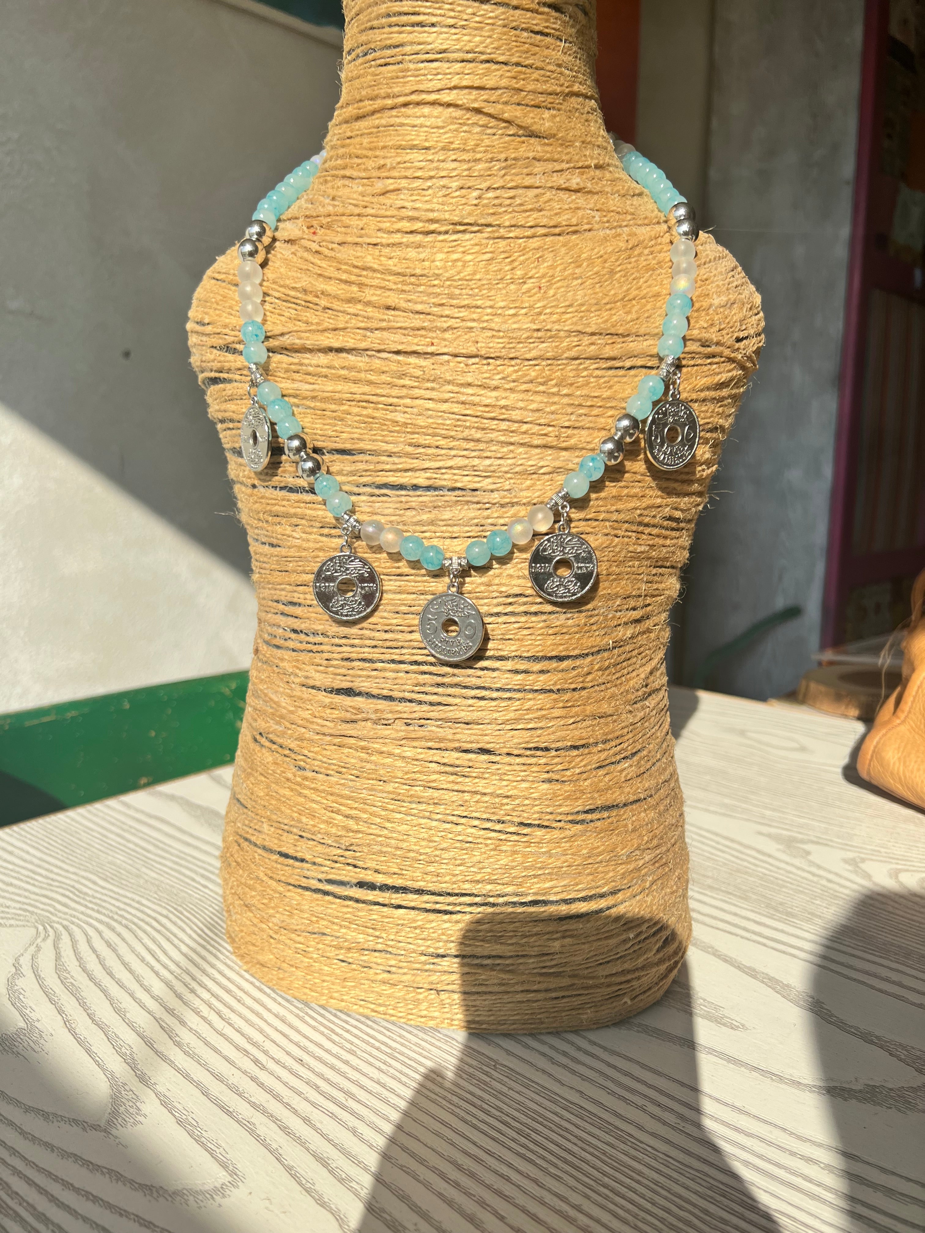 Baby blue necklace with five silver coin