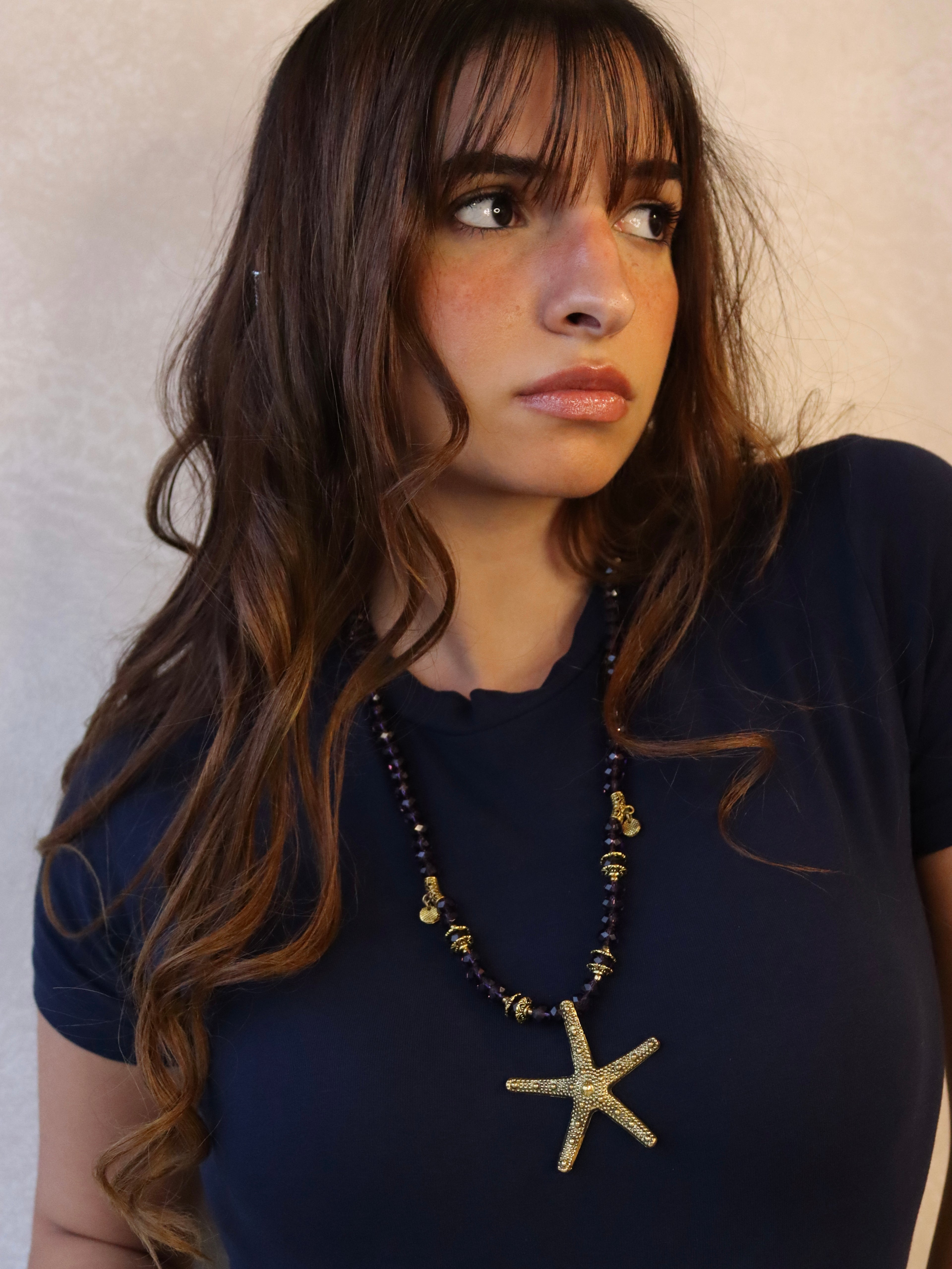 purple crystal necklace with gold metal star fish