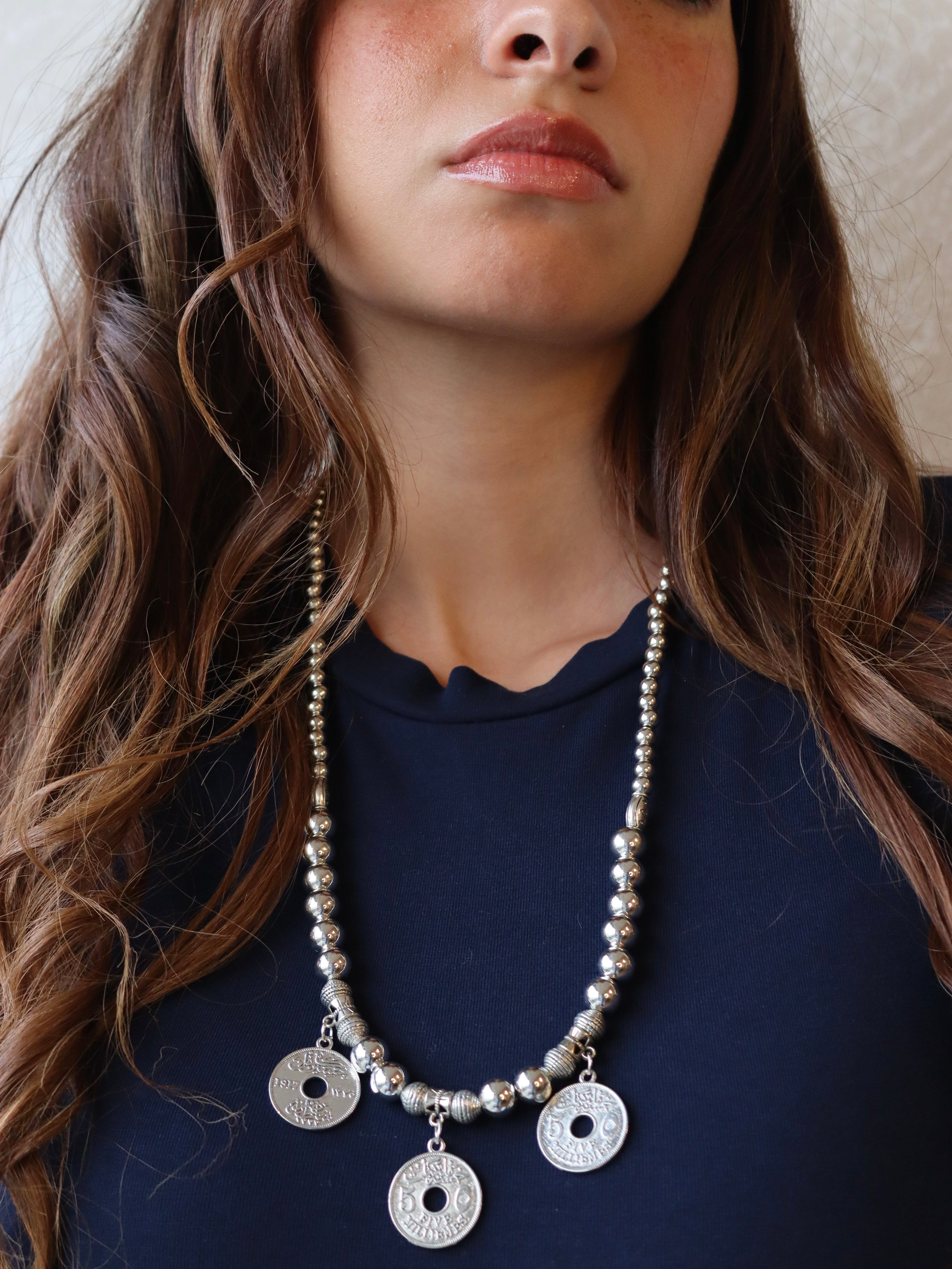 silver necklace with three silver coin