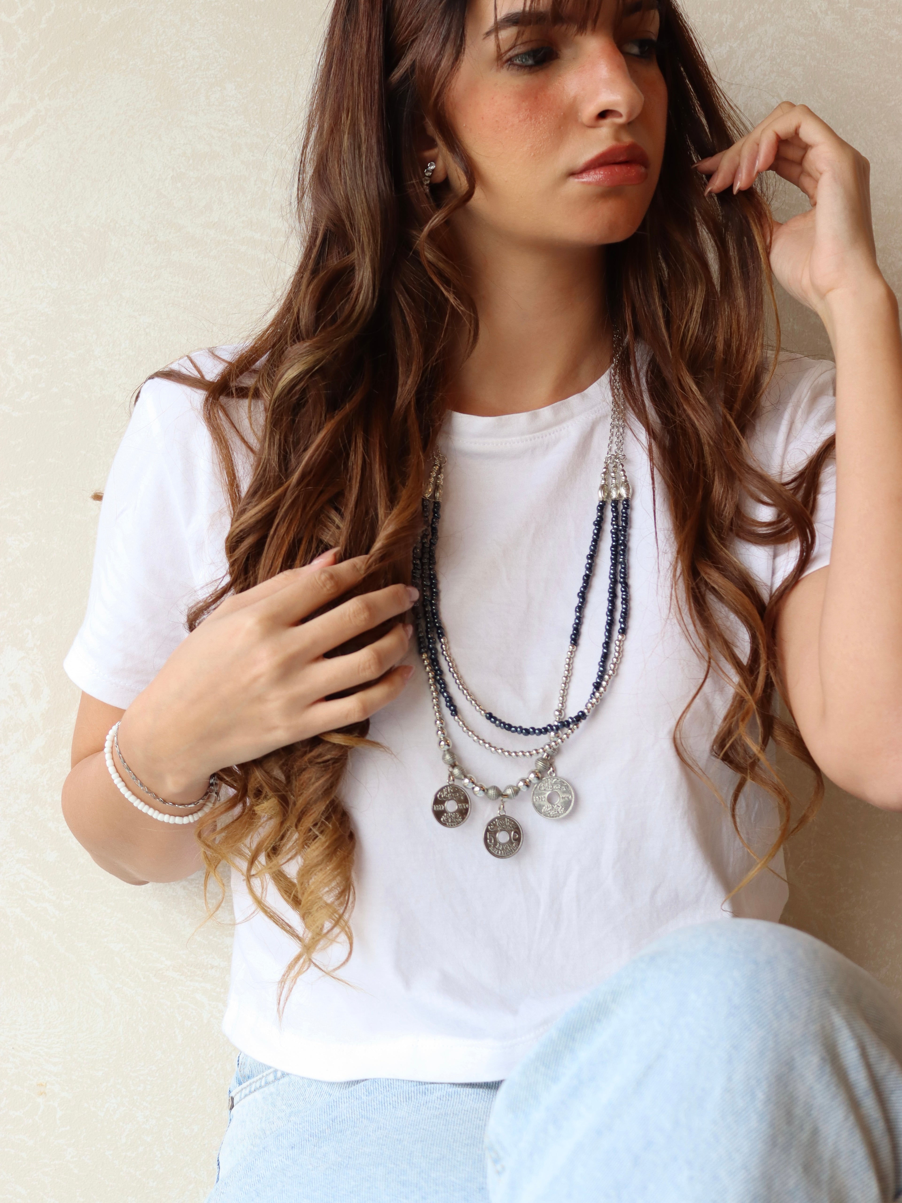 blue triple layered beaded necklace with three silver coins